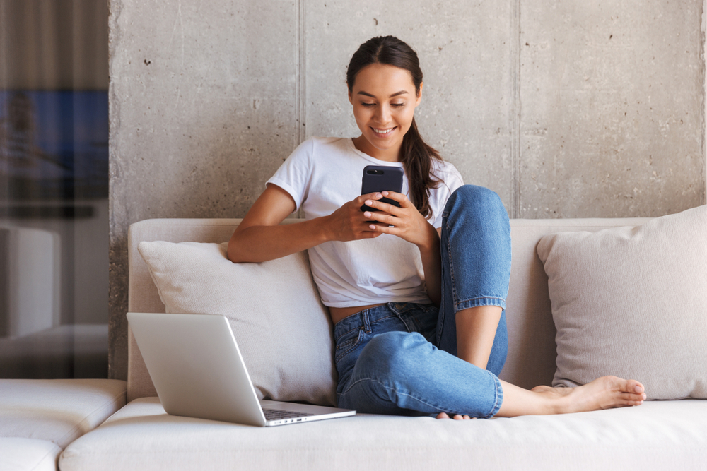 woman looking at phone while shopping
